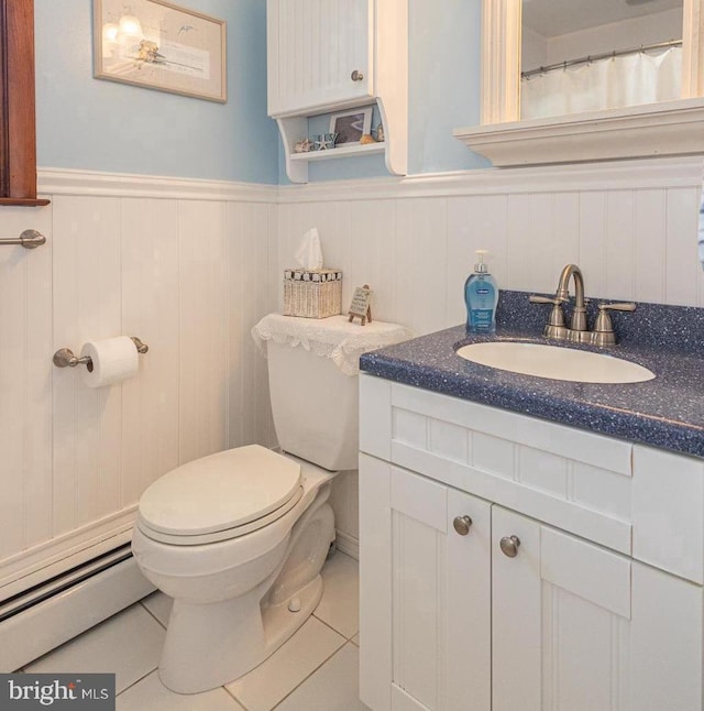 bathroom featuring vanity, a baseboard heating unit, toilet, and tile patterned floors