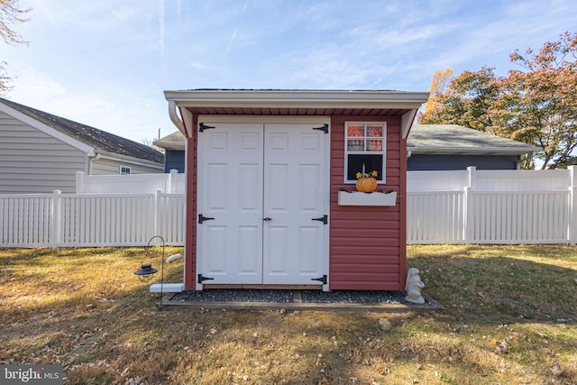 view of outbuilding featuring a lawn