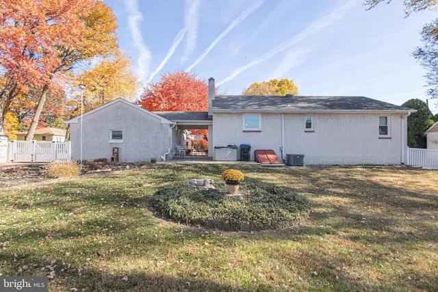 rear view of house featuring a yard, cooling unit, and a patio