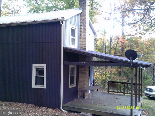 view of side of property featuring a wooden deck