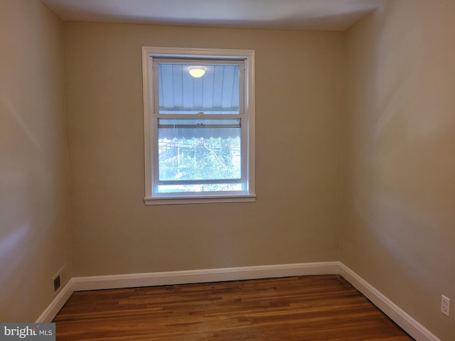 spare room with dark wood-type flooring