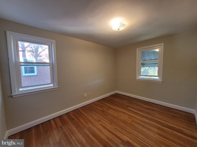 spare room with dark wood-type flooring