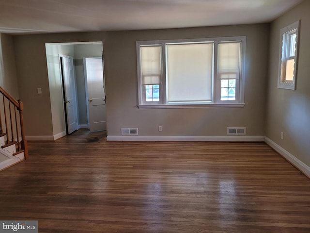 unfurnished room featuring dark hardwood / wood-style flooring