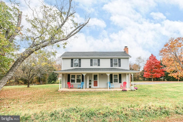 view of front of house featuring covered porch and a front yard