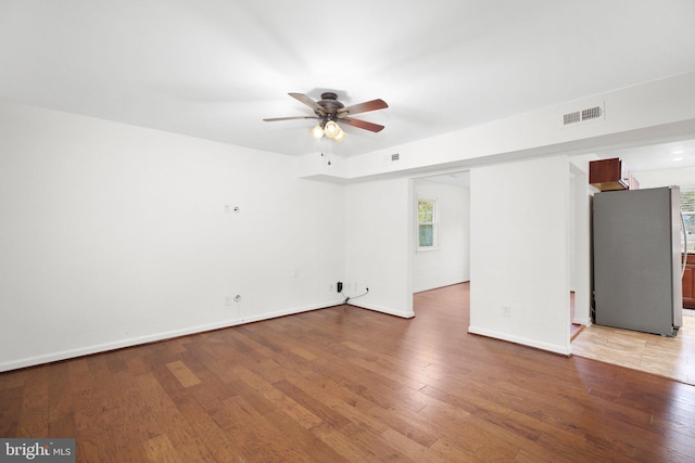 unfurnished room with hardwood / wood-style flooring and ceiling fan