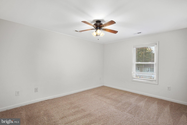 spare room featuring ceiling fan and carpet floors