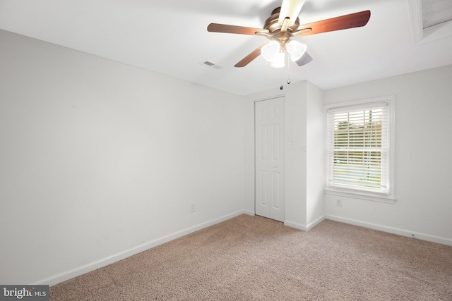 unfurnished bedroom with carpet flooring, ceiling fan, and a closet