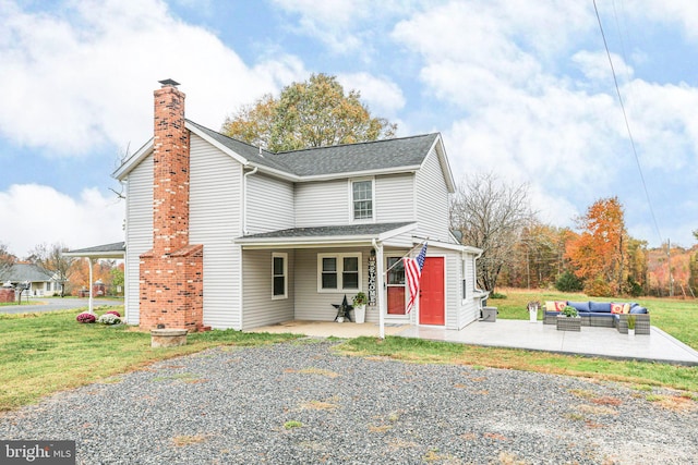 view of front of home featuring a patio area, an outdoor hangout area, and a front lawn