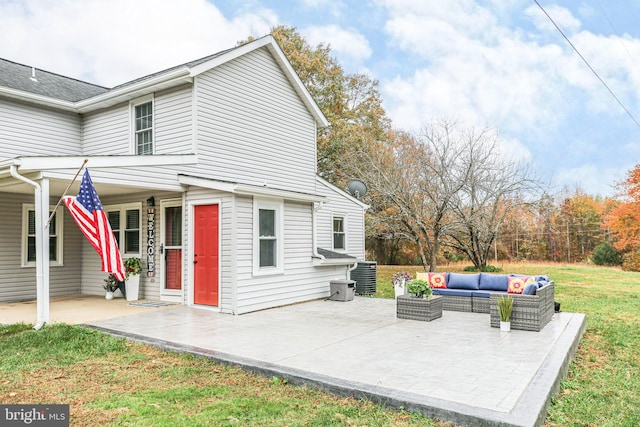 view of property exterior with a lawn, a patio area, an outdoor living space, and cooling unit