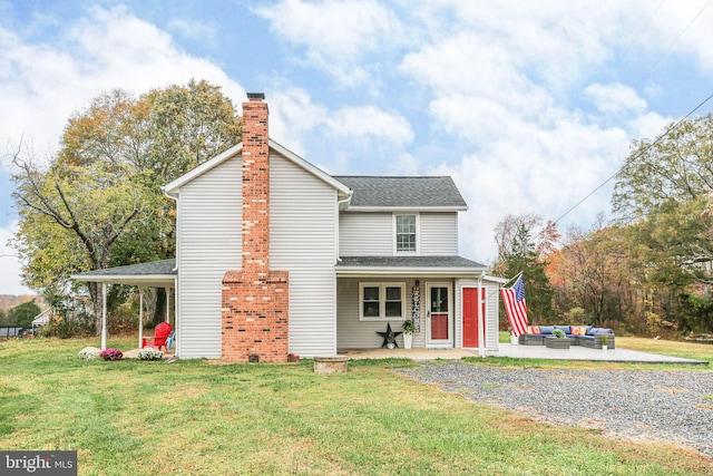 view of property featuring a patio area, an outdoor hangout area, and a front lawn