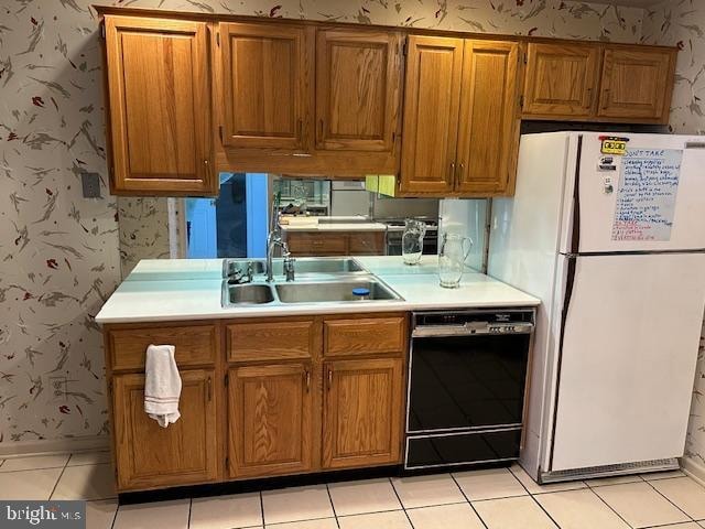 kitchen featuring white fridge, sink, light tile patterned floors, and black dishwasher