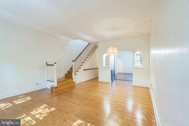 unfurnished living room with hardwood / wood-style flooring