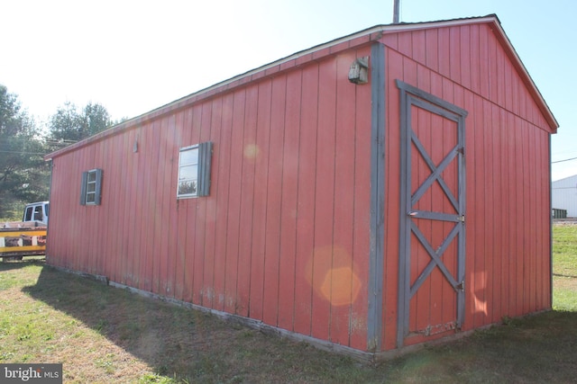 view of outbuilding with a yard