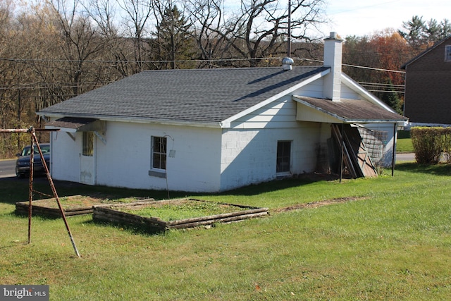 rear view of property with a lawn