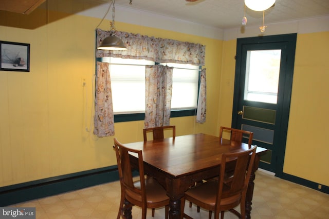 dining space with ornamental molding