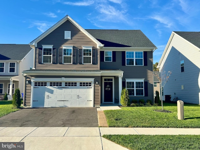 view of front of home with a front lawn and a garage