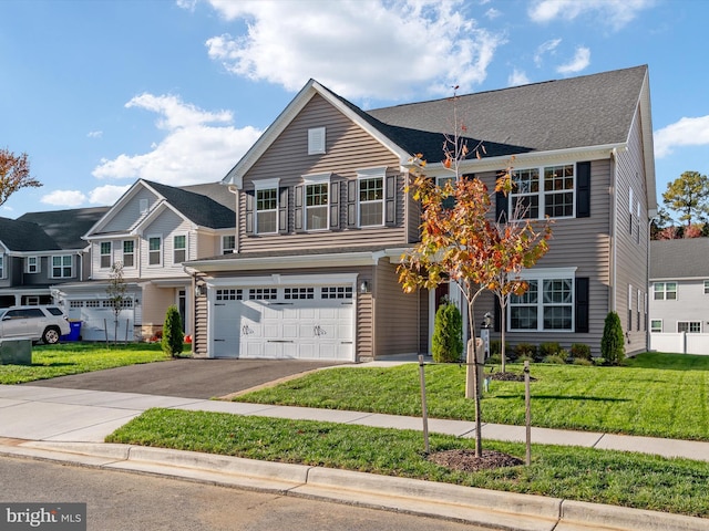 view of front of house with a front yard and a garage