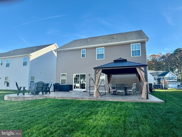 rear view of property with a gazebo, a patio area, and a yard