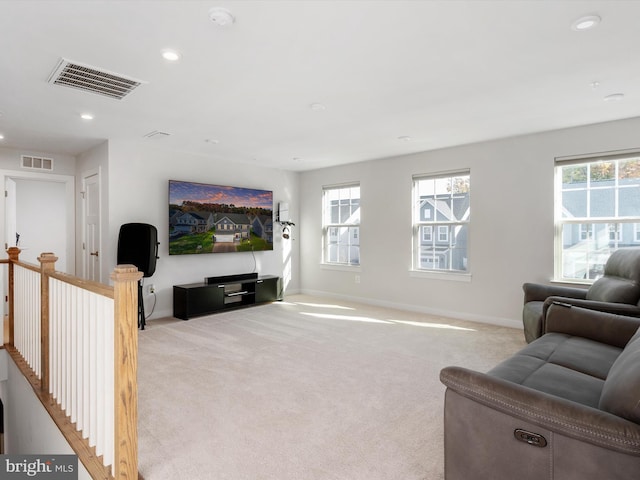 carpeted living room with a healthy amount of sunlight