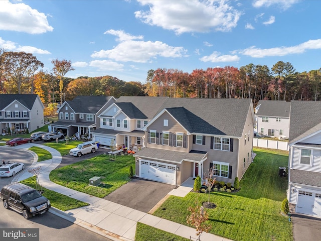 view of front of property with a garage and a front yard