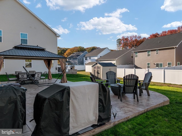 view of patio featuring a gazebo, area for grilling, and a storage shed