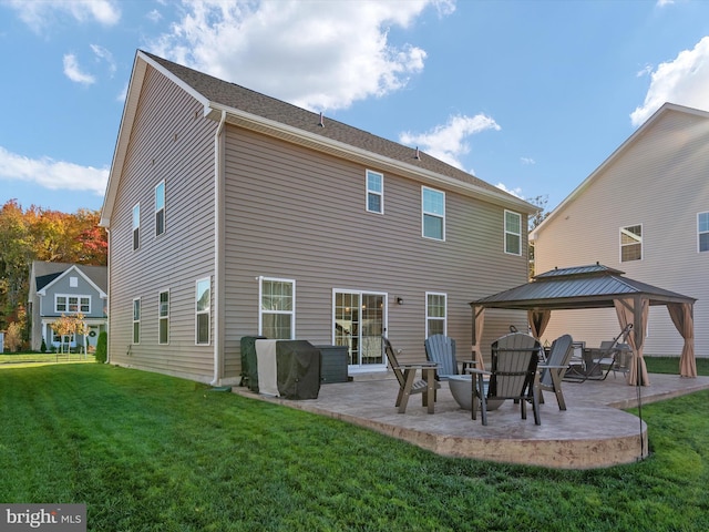 back of property featuring a gazebo, a patio, and a lawn