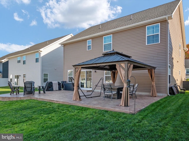 back of property featuring a gazebo, a patio area, and a lawn