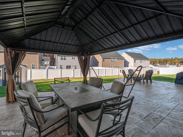 view of patio with a gazebo and a storage shed