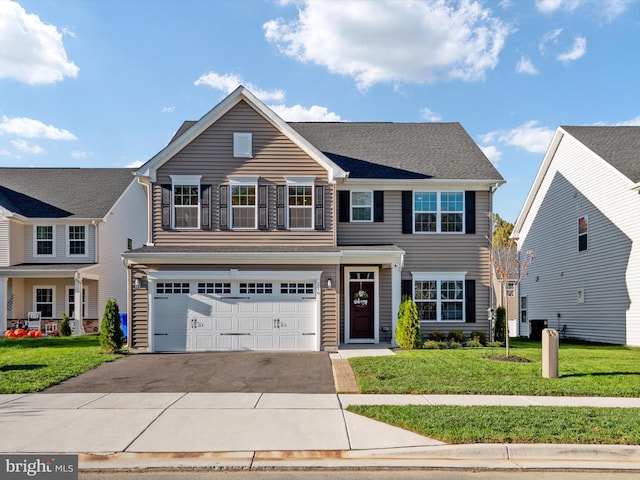 view of front of house featuring a front lawn and a garage