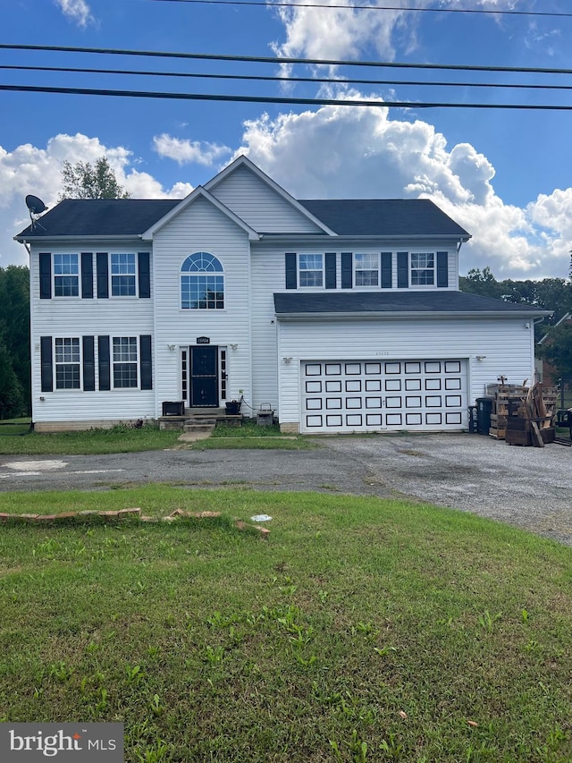 front of property featuring a garage and a front yard