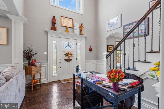 entryway featuring a high ceiling and dark hardwood / wood-style flooring