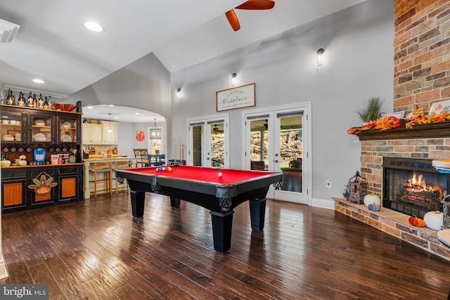 recreation room with pool table, a fireplace, french doors, dark hardwood / wood-style flooring, and high vaulted ceiling