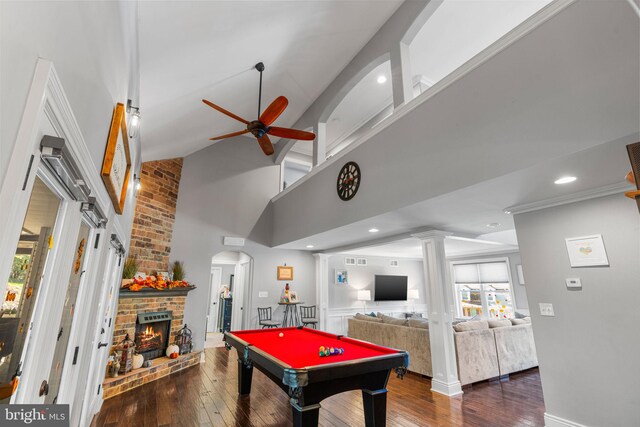 rec room with billiards, ceiling fan, wood-type flooring, ornate columns, and a fireplace