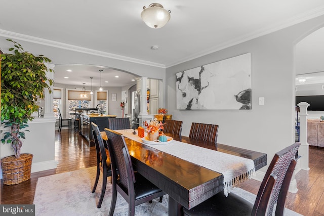 dining space with ornamental molding and hardwood / wood-style floors