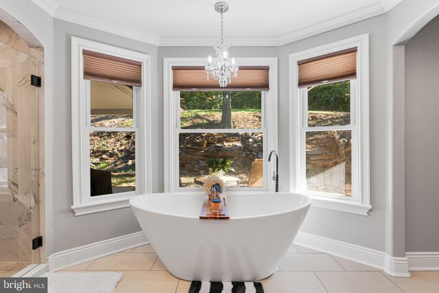 tiled dining area featuring crown molding and a notable chandelier