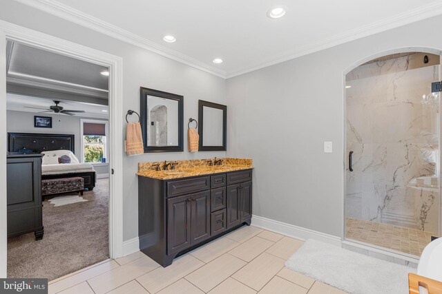 bathroom with vanity, ornamental molding, a shower with shower door, and ceiling fan