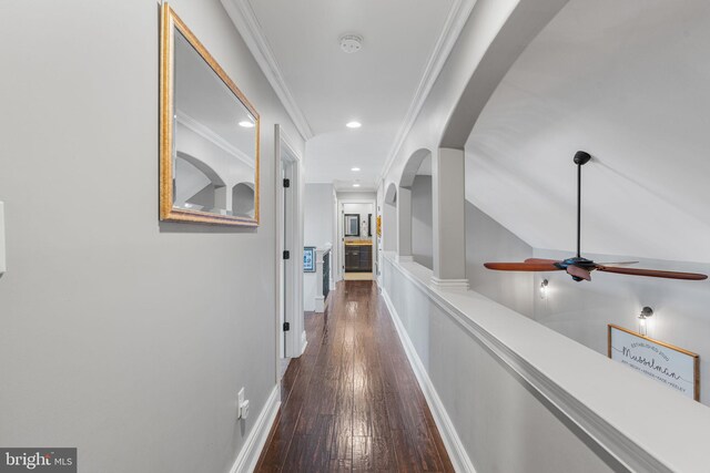 hall featuring ornamental molding and dark hardwood / wood-style flooring