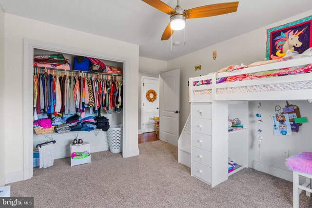 carpeted bedroom featuring a closet and ceiling fan