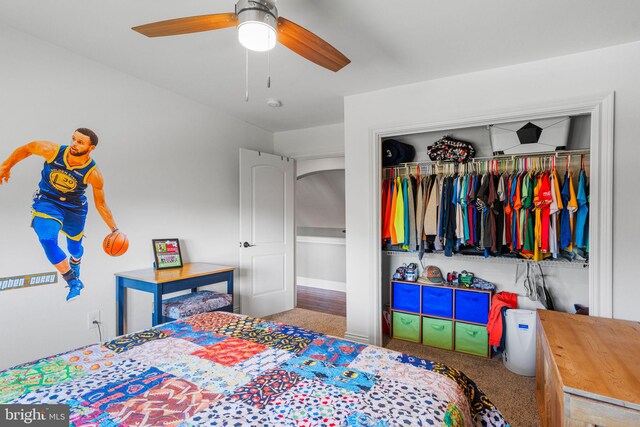 carpeted bedroom with a closet and ceiling fan