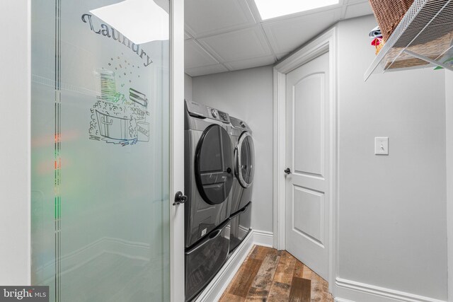 laundry room with hardwood / wood-style floors and washer and dryer