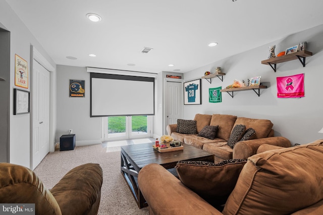 carpeted home theater room with french doors