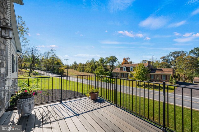 wooden terrace with a lawn