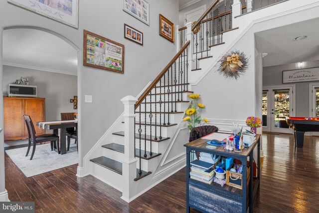 stairway featuring crown molding, pool table, and wood-type flooring