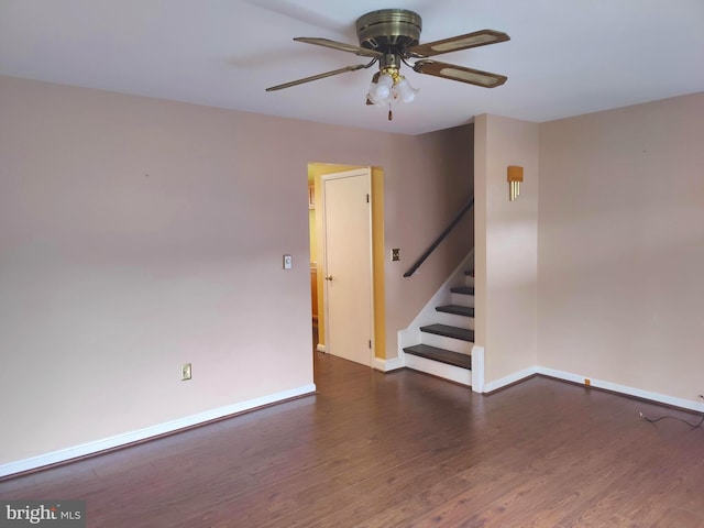 empty room featuring ceiling fan and dark wood-type flooring