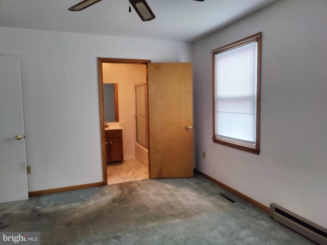 unfurnished bedroom with ceiling fan, light colored carpet, connected bathroom, and a baseboard radiator