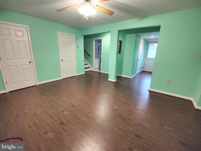 unfurnished room featuring ceiling fan and dark wood-type flooring