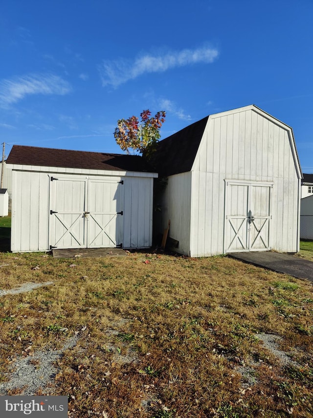 view of outbuilding featuring a lawn