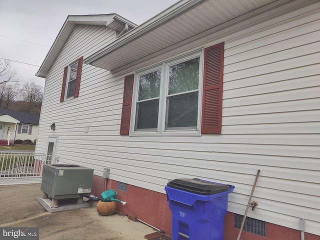 view of side of home with central AC unit