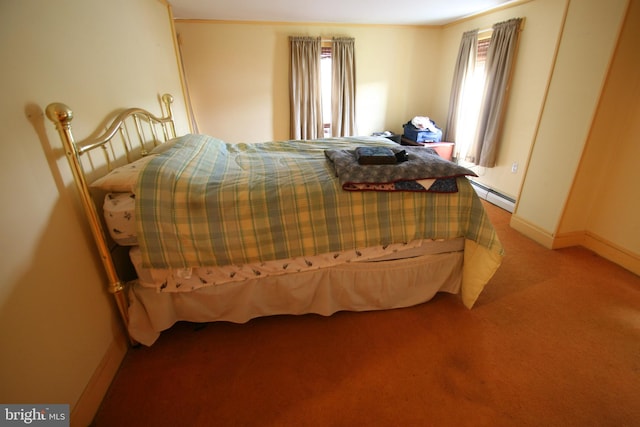 bedroom with a baseboard radiator and light colored carpet