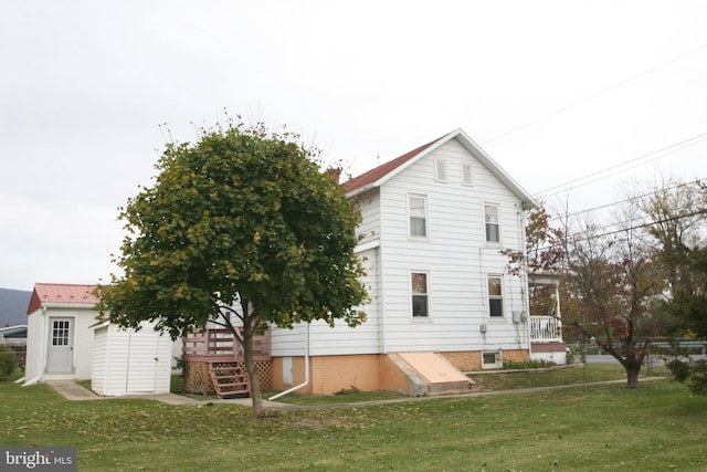 back of property featuring a yard